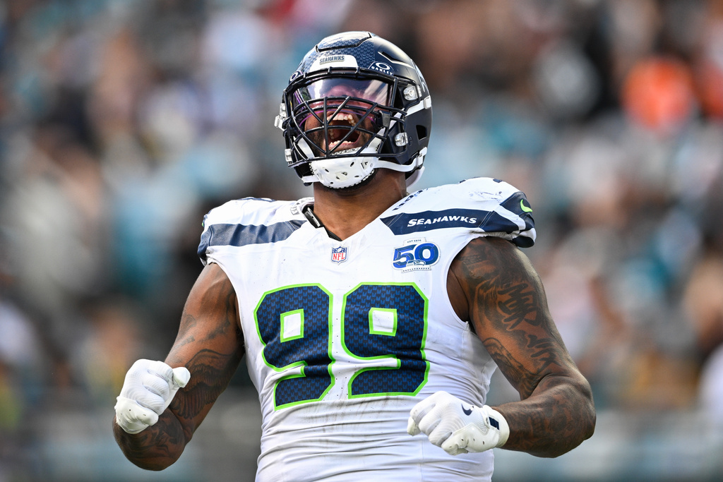Seattle Seahawks defensive end Leonard Williams (99) reacts after sacking Jacksonville Jaguars quarterback Trevor Lawrence during the first half of an NFL football game Sunday, Oct. 12 2025, in Jacksonville, Fla. (AP Photo/Phelan M. Ebenhack)
