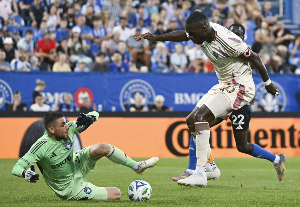 CF Montreal goalkeeper Thomas Gillier, left, makes a save against D.C. United's Christian Benteke, front right, during first-half MLS soccer match action in Montreal, Saturday, Aug. 16, 2025. (Graham Hughes/The Canadian Press via AP)