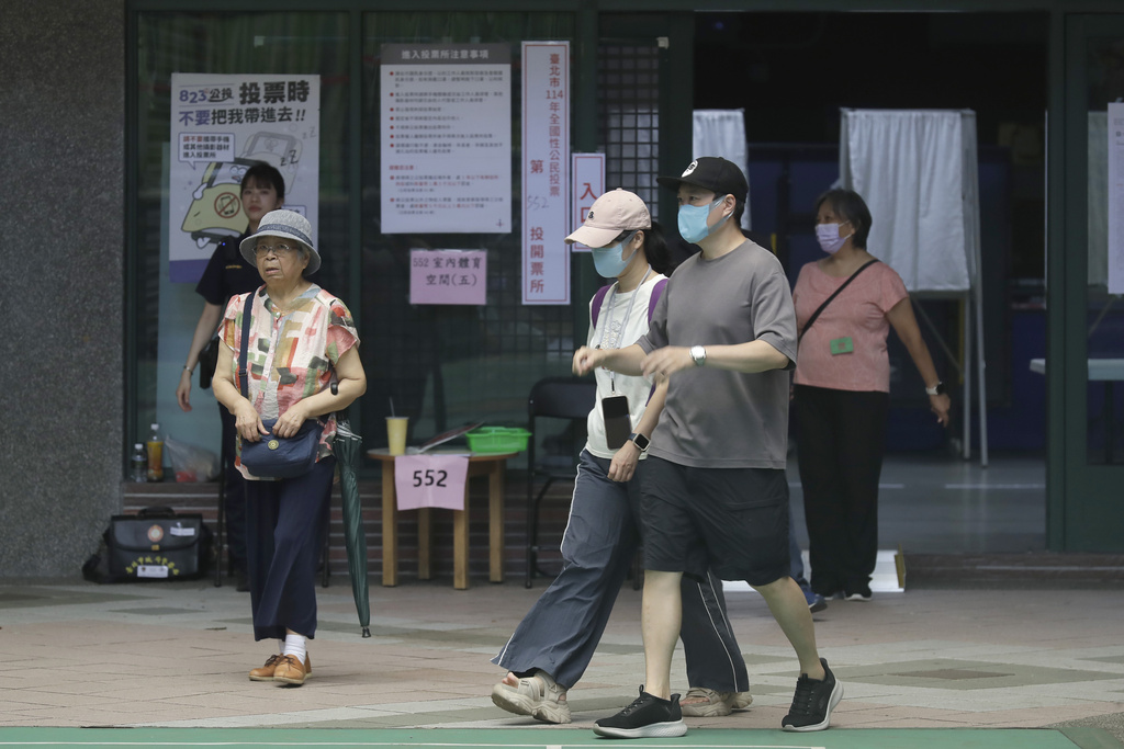People go to vote at a polling station in Taipei, Taiwan, Saturday, Aug. 23, 2025, during the vote which includes a referendum on restarting the Maanshan nuclear power plant.(AP Photo/Chiang Ying-ying)
