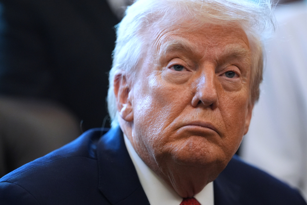 President Donald Trump listens before he signs an executive order reclassifying marijuana as a less dangerous drug in the Oval Office of the White House, Thursday, Dec. 18, 2025, in Washington. (AP Photo/Evan Vucci)