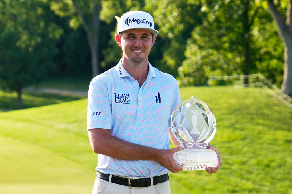 J.T. Poston poses with the trophy after winning the Memorial golf tournament, Sunday, June 7, 2026, in Dublin, Ohio. (AP Photo/Sue Ogrocki)
