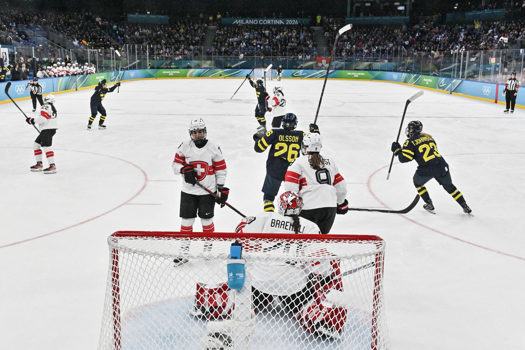 Sweden's players celebrate scoring the opening goal during a women's ice hockey bronze medal game between Switzerland and Sweden at the 2026 Winter Olympics, in Milan, Italy, Thursday, Feb. 19, 2026. (Alexander Nemenov/Pool Photo via AP)