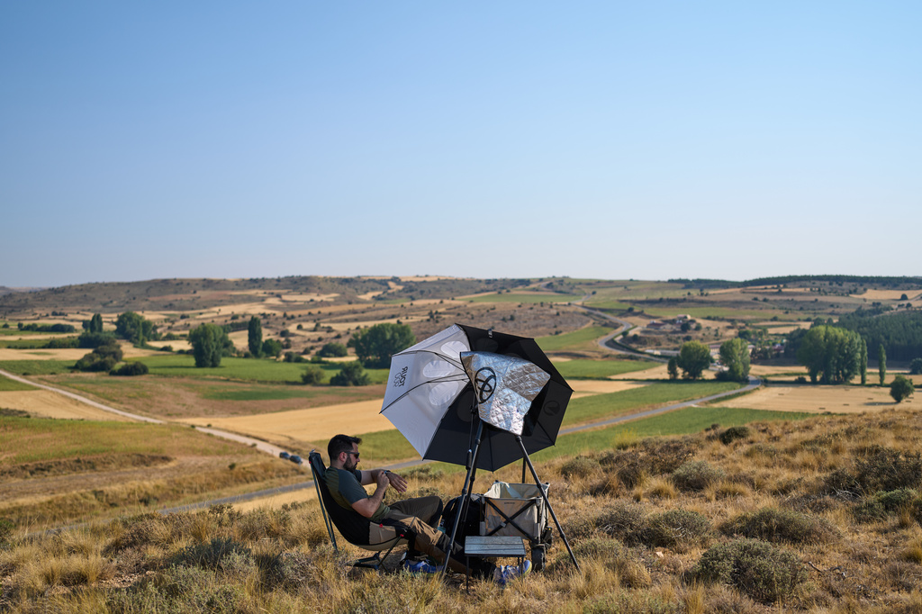 Mario Garrido, a member of the "Los Taraos" amateur astrophotography group, waits to shoot a total solar eclipse in Berlanga de Duero, central Spain, Wednesday, Aug. 12, 2026. (AP Photo/Bernat Armangue)