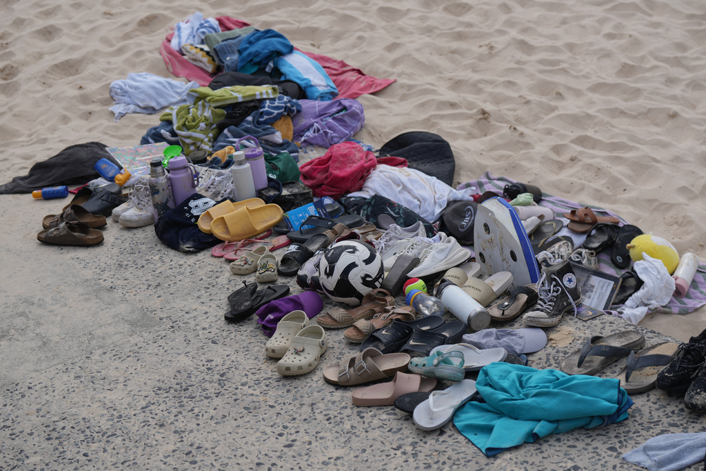 Belongings sit piled up after a shooting the day prior at Sydney's Bondi Beach, Monday, Dec. 15, 2025. (AP Photo/Mark Baker)