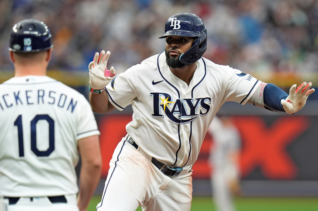 Tampa Bay Rays' Junior Caminero, right, celebrates after his single off Boston Red Sox pitcher Garrett Whitlock during the ninth inning of a baseball game Saturday, Sept. 19, 2026, in St. Petersburg, Fla. (AP Photo/Chris O'Meara)