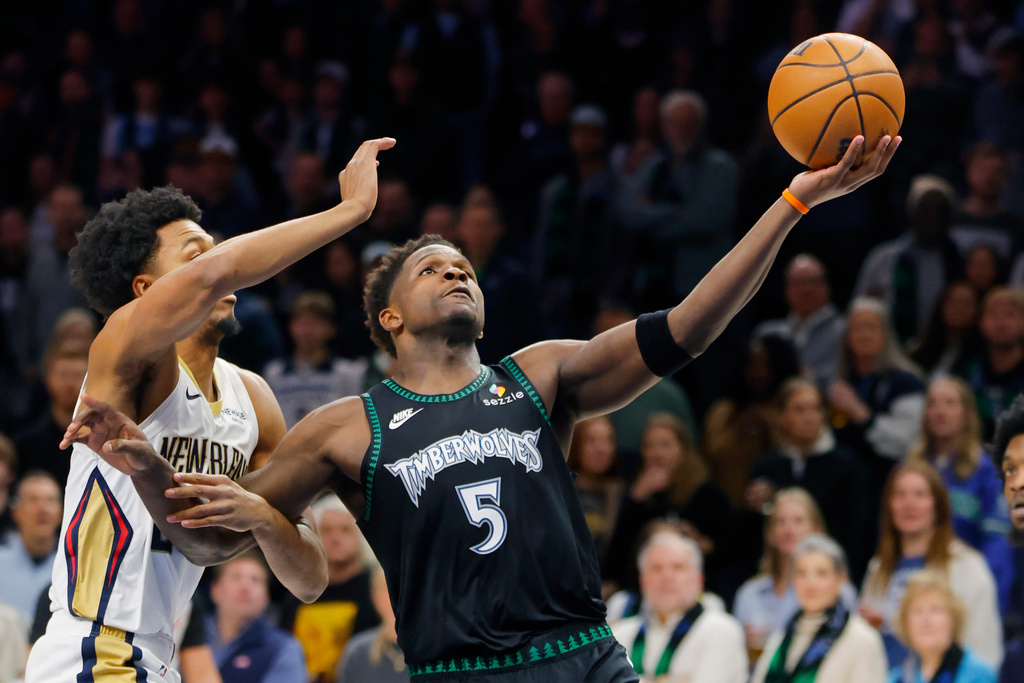 Minnesota Timberwolves guard Anthony Edwards (5) goes to the basket against New Orleans Pelicans forward Trey Murphy III, left, in the first quarter of an NBA basketball game Friday, Feb. 6, 2026, in Minneapolis. (AP Photo/Bruce Kluckhohn)