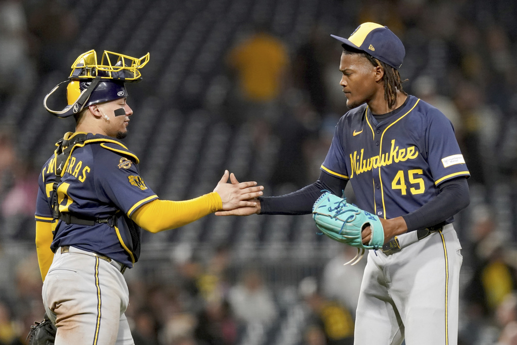 Milwaukee Brewers pitcher Abner Uribe, right, celebrates with catcher William Contreras, left, after getting the final out of a baseball game against the Pittsburgh Pirates, Friday, Sept. 5, 2025, in Pittsburgh. (AP Photo/Matt Freed)
