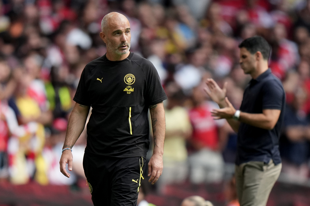 Manchester City's head coach Enzo Maresca, left, and Arsenal's manager Mikel Arteta react during the FA Community Shield final soccer match between Arsenal and Manchester City in Cardiff, Wales, Sunday, Aug.16, 2026. (AP Photo/Alastair Grant)
