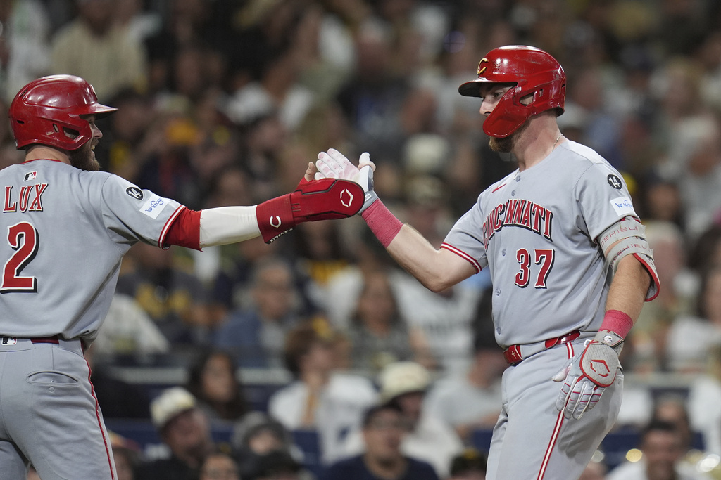 Cincinnati Reds' Tyler Stephenson (37) celebrates with teammate Gavin Lux after hitting a two-run home run during the ninth inning of a baseball game against the San Diego Padres Tuesday, Sept. 9, 2025, in San Diego. (AP Photo/Gregory Bull)