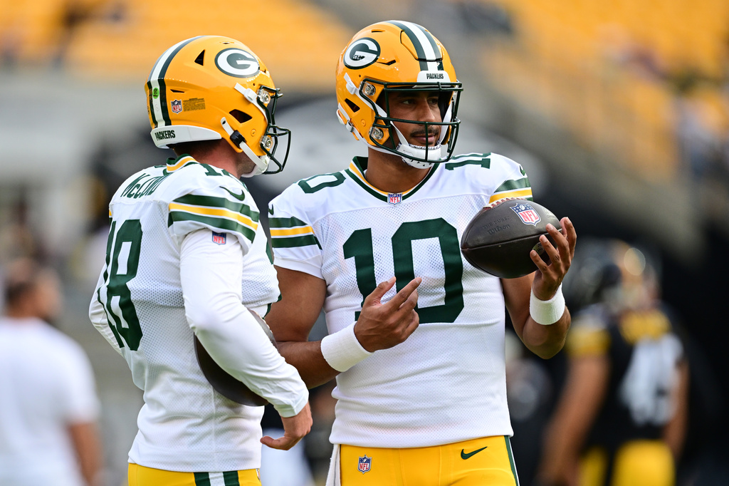 Green Bay Packers' Kyle McCord, left, and Jordan Love (10) talk on the field during warmups before a preseason NFL football game against the Pittsburgh Steelers in Pittsburgh, Thursday, Aug. 13, 2026. (AP Photo/David Dermer)