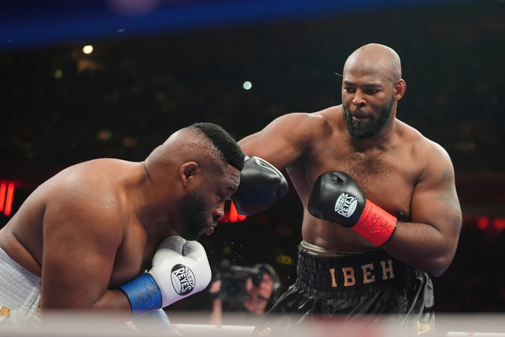 Kingsley Ibeh=, right, punches Jarrell Miller during a heavyweight boxing match Saturday, Jan. 31, 2026, in New York. (AP Photo/Frank Franklin II)