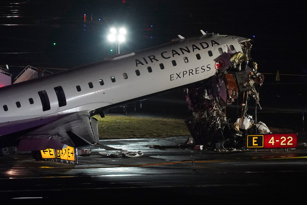 An Air Canada Jet sits on the runway at LaGuardia Airport, Monday, March 23, 2026, after colliding with a Port Authority aircraft rescue and firefighting vehicle after landing in New York. (AP Photo/Ryan Murphy)