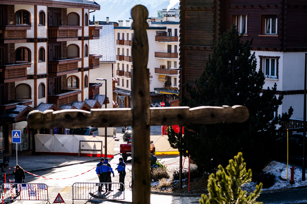 Police officers inspect the area where a fire broke out at the Le Constellation bar and lounge leaving people dead and injured, during New Year’s celebration, in Crans-Montana, Swiss Alps, Switzerland, Thursday, Jan. 1, 2026. (Jean-Christophe Bott/Keystone via AP)