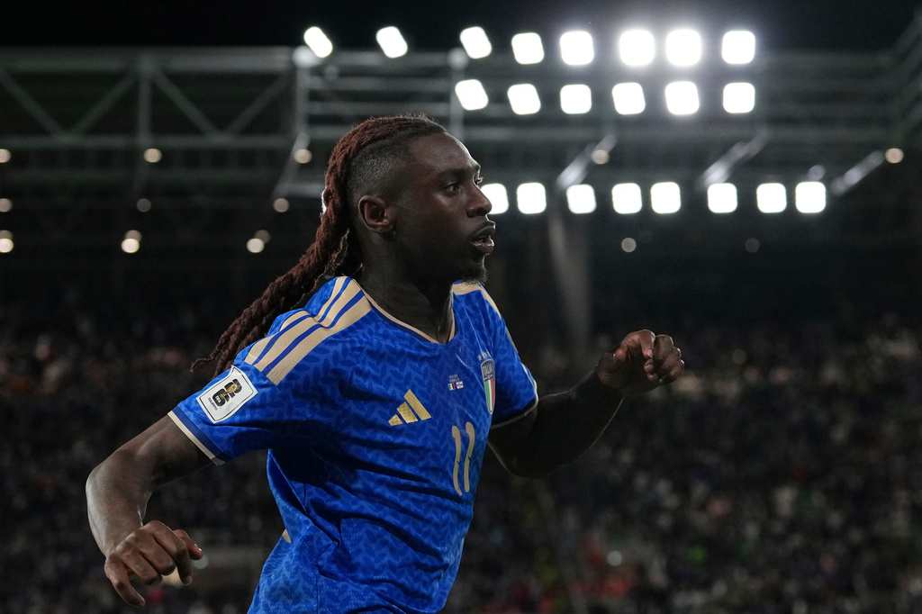 Italy's Moise Kean celebrates scoring his side's second goal during the World Cup qualifying play-off soccer match between Italy and Northern Ireland, in Bergamo, Italy, Thursday, March 26, 2026. (AP Photo/Antonio Calanni)