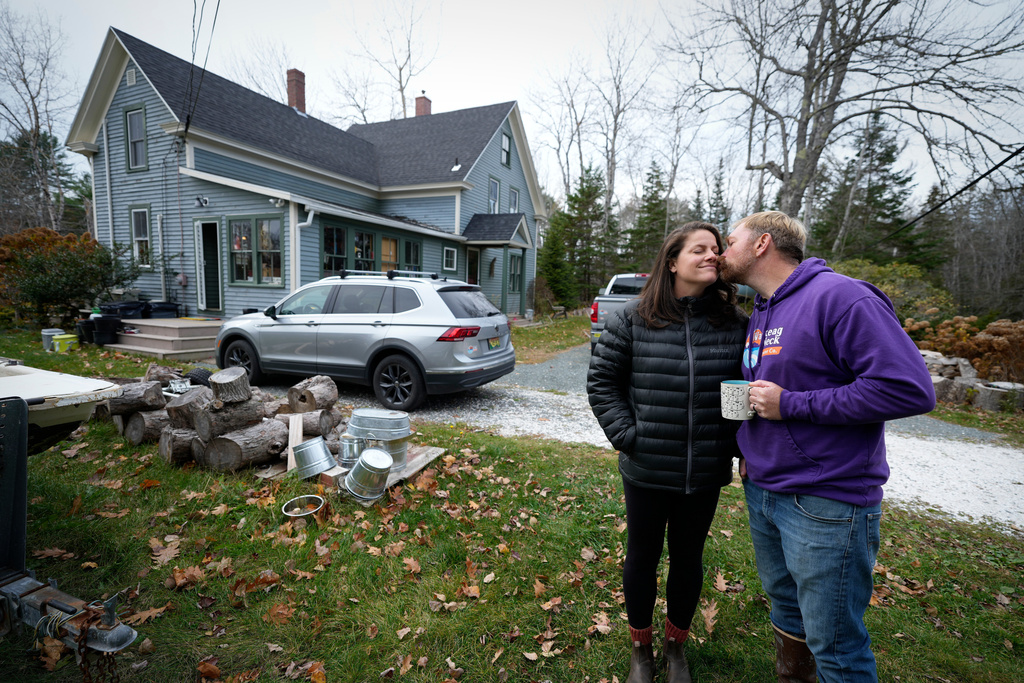 Graham Platner, Democratic candidate for U.S. Senate, kisses his wife, Amy Gertner, before she heads out, Monday, Nov. 3, 2025, in Sullivan, Maine. (AP Photo/Robert F. Bukaty)