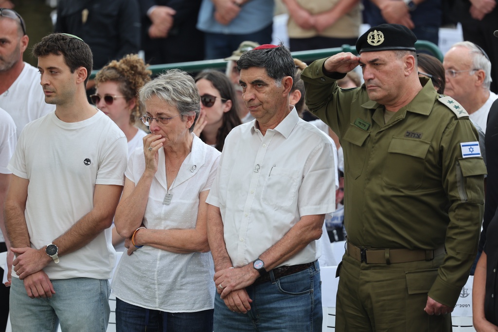 IDF chief of staff Eyal Zamir, right, with Simha Goldin and Leah Goldin, the parents and siblings of Hadar Goldin an Israeli soldier killed in Gaza in 2014 and whose body had been held there until it was released Sunday, attend his funeral in Kfar Saba, Israel, Tuesday, Nov. 11, 2025. (Abir Sultan/Pool via AP)