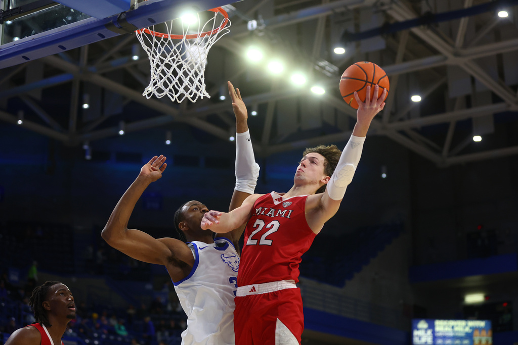Miami (OH) guard Evan Ipsaro (2) shoots against Buffalo center Tim Oboh (33) during the first half of an NCAA college basketball game Tuesday, Feb. 3, 2026, in Buffalo, N.Y. (AP Photo/Jeffrey T. Barnes)