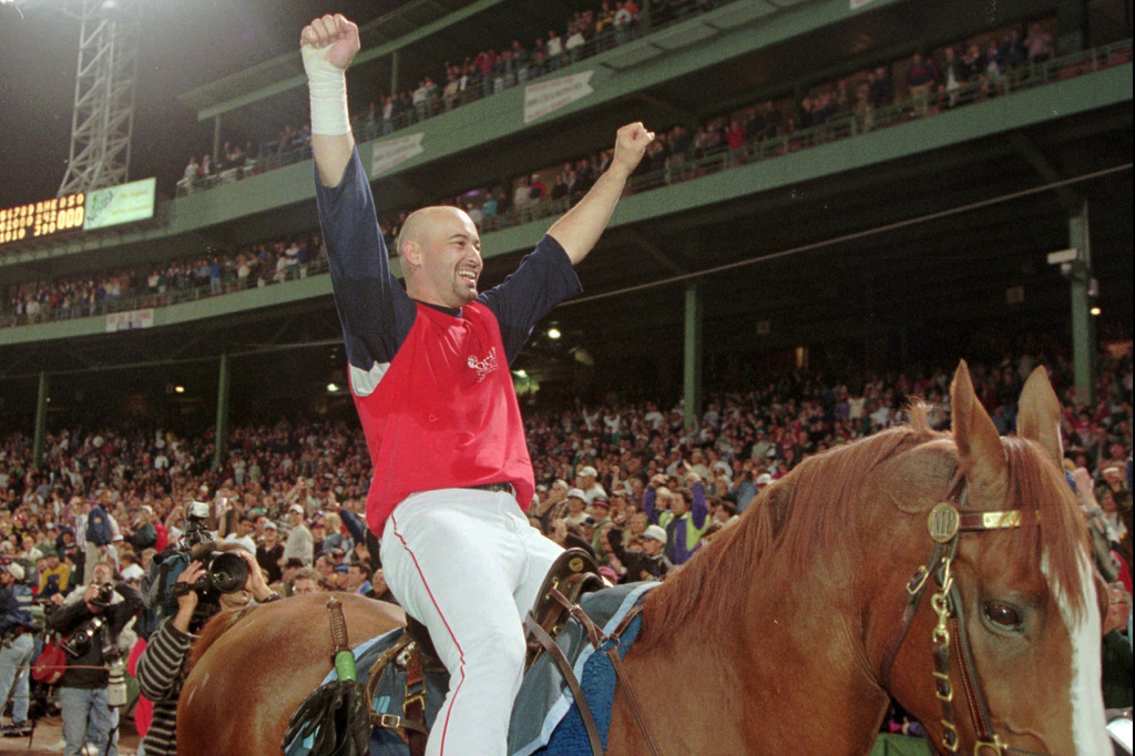 FILE - Boston Red Sox outfielder Mike Greenwell cheers from atop a police horse while riding around Fenway Park in Boston, Wednesday, Sept. 20, 1995, after the Red Sox clinched the American League East Championship. (AP Photo/Winslow Townson, File)