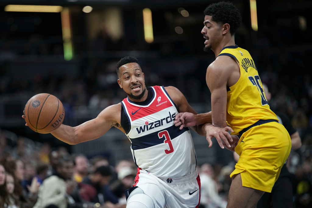 Washington Wizards guard CJ McCollum, left, moves around Indiana Pacers guard Ben Sheppard during the first half of an NBA Cup basketball game in Indianapolis, Friday, Nov. 28, 2025. (AP Photo/AJ Mast)