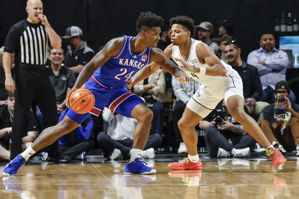 Kansas forward KJ Adams Jr. (24) drives against Central Florida guard Keyshawn Hall (4) during the first half of an NCAA college basketball game, Sunday, Jan. 5, 2025, in Orlando, Fla. (AP Photo/Kevin Kolczynski)