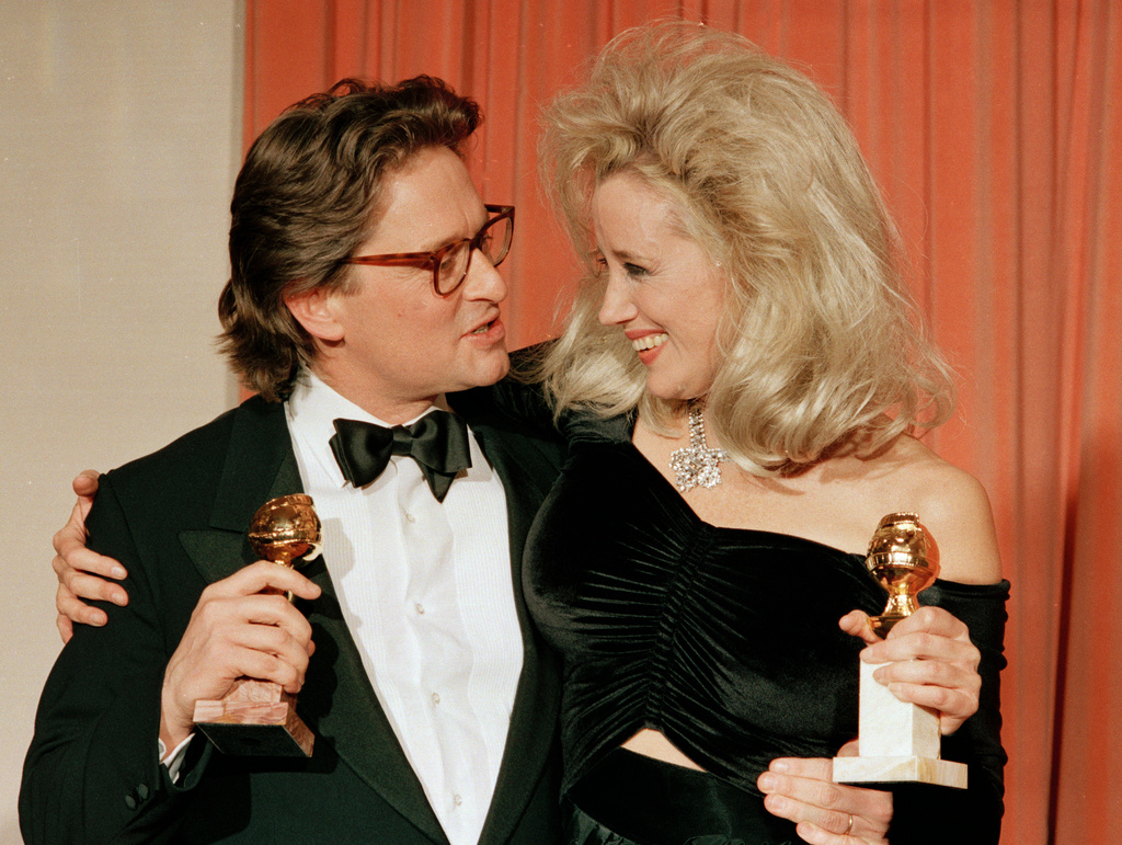 FILE - Michael Douglas, left, and Sally Kirkland appear with their awards for best actor for "Wall Street" and best actress for "Anna," at the 45th Annual Golden Globe Awards in Beverly Hills, Calif., on Jan. 24, 1988. (AP Photo/Reed Saxon, File)