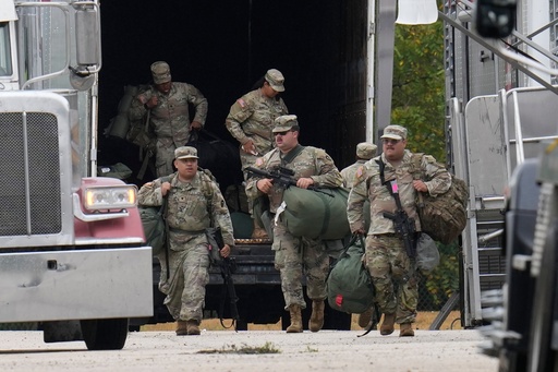 Military personnel in uniform, with the Texas National Guard patch on, are seen at the U.S. Army Reserve Center, Tuesday, Oct. 7, 2025, in Elwood, Ill., a suburb of Chicago. (AP Photo/Erin Hooley) Military personnel in uniform, with the Texas National Guard patch on, are seen at the U.S. Army Reserve Center, Tuesday, Oct. 7, 2025, in Elwood, Ill., a suburb of Chicago. (AP Photo/Erin Hooley)