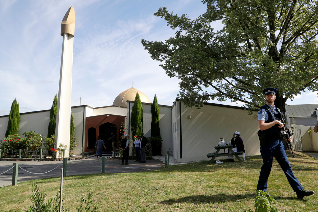 FILE - An armed policeman patrols the grounds at the Al Noor mosque March 23, 2019, in Christchurch, New Zealand, following the previous week's mass shooting. (AP Photo/Mark Baker, File)