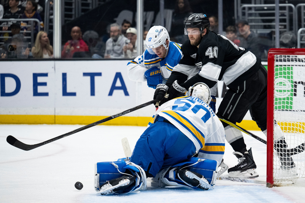 Los Angeles Kings right wing Joel Armia (40) and St. Louis Blues defenseman Cam Fowler (17) vie for the puck during the second period of an NHL hockey game, Wednesday, April 1, 2026, in Los Angeles. (AP Photo/Kyusung Gong)