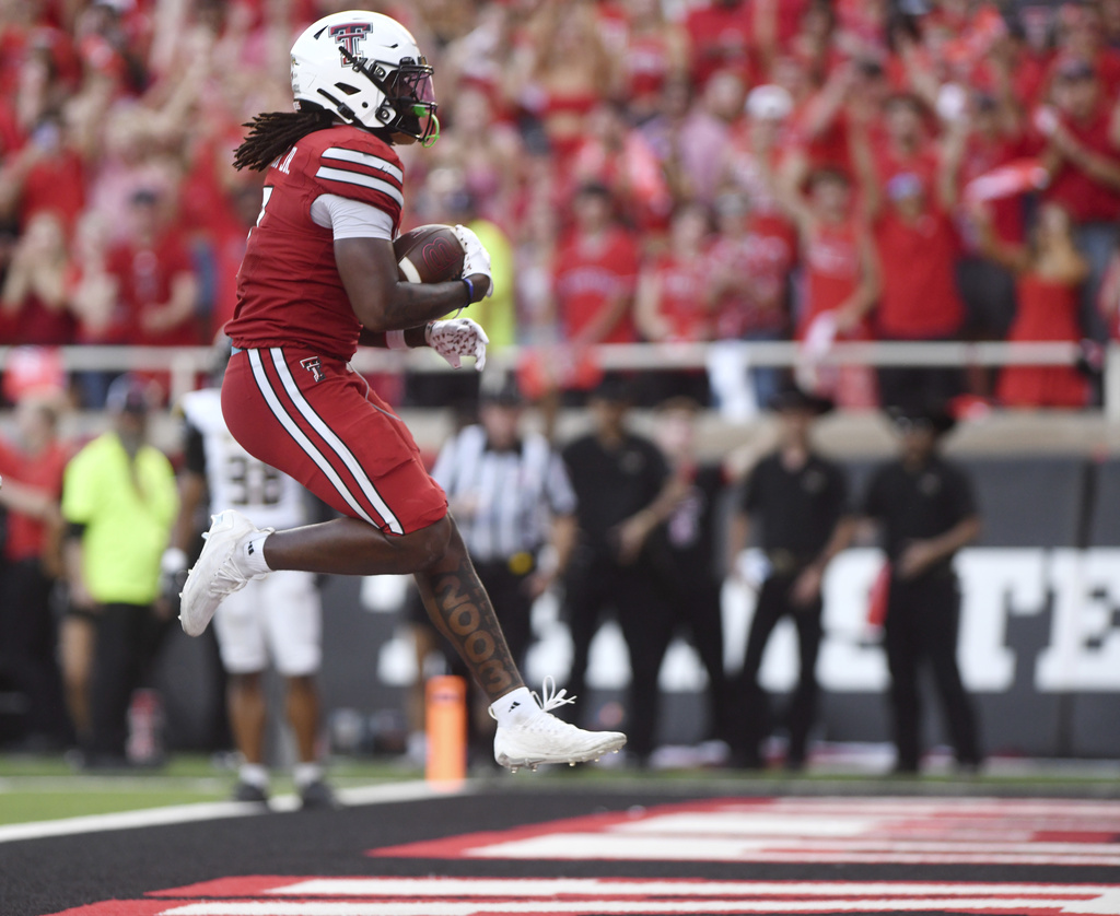 Texas Tech tight end Terrance Carter Jr. (7) jumps into the end zone to score a touchdown during the first half of an NCAA college football game against Arkansas-Pine Bluff, Saturday, Aug. 30, 2025, in Lubbock, Texas. (AP Photo/Annie Rice)