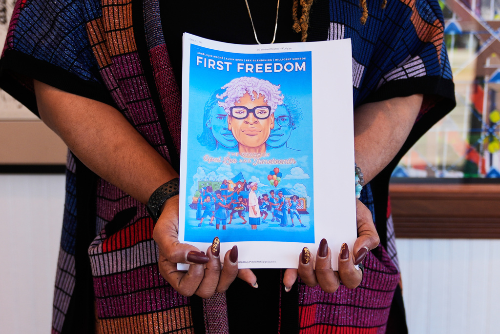 Angelique Roche holds a printout of her upcoming Book "First Freedom: The Story of Opal Lee and Juneteenth," at the Ashe Cultural Arts Center, Thursday, Jan. 29, 2026, in New Orleans. (AP Photo/Gerald Herbert)