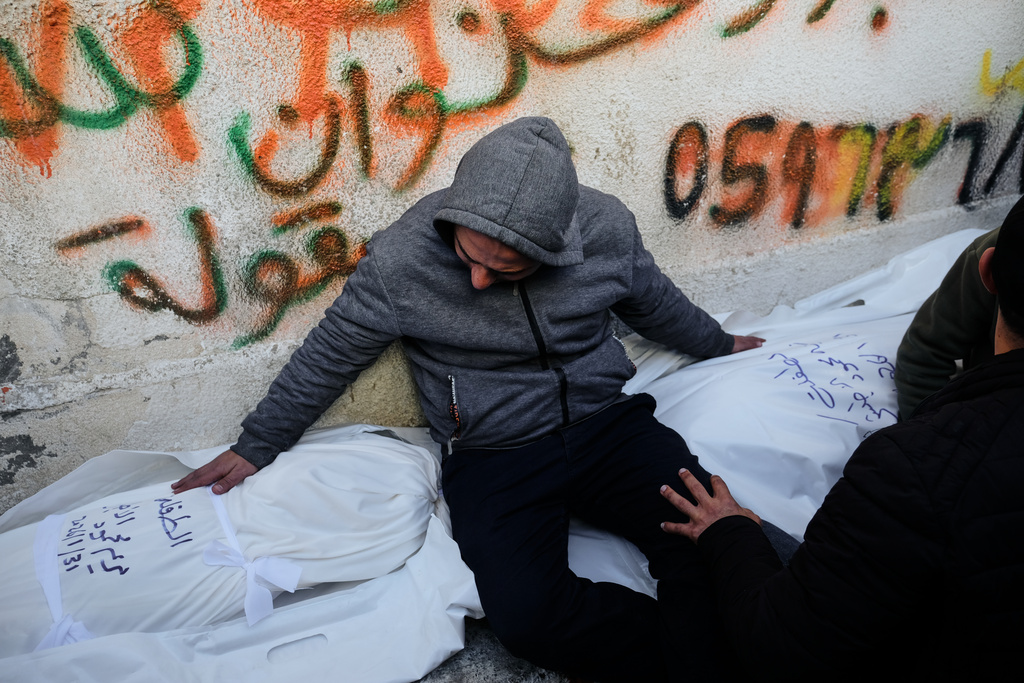 Mahmoud Al-Atbash mourns the bodies of his two daughters, Zeina and Maryam, who were killed in an Israeli military strike, at Shifa Hospital in Gaza City Saturday, Jan. 31, 2026. (AP Photo/Jehad Alshrafi)