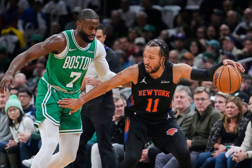 New York Knicks guard Jalen Brunson (11) sets to drive against Boston Celtics guard Jaylen Brown (7) during the first half of an NBA basketball game, Tuesday, Dec. 2, 2025, in Boston. (AP Photo/Charles Krupa)