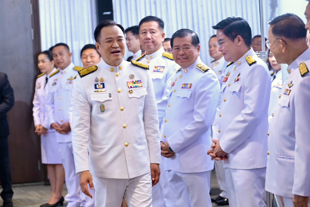 In this photo released by the Thai government spokesman office, Thailand's new Prime Minister Anutin Charnvirakul, left, talks to Bhumjai Thai lawmakers at Bhumjai Thai party Headquarters after receiving a royal endorsement in Bangkok, Thailand, Sunday, Sept. 7, 2025. (Thai government spokesman office via AP)