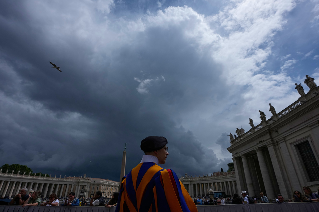 A Swiss Guard stands as dark clouds hang over, during Pope Leo XIV's weekly general audience in St. Peter's Square, at the Vatican, Wednesday, May 13, 2026. (AP Photo/Alessandra Tarantino)