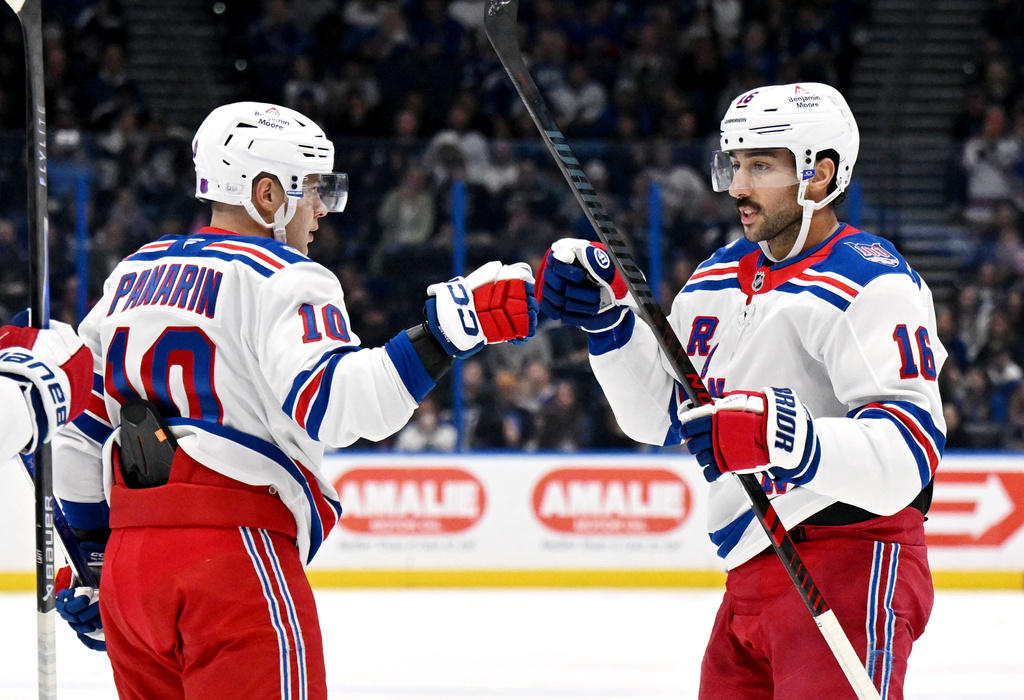 New York Rangers left wing Artemi Panarin (10) and center Vincent Trocheck (16) celebrate Trocheck's goal during the third period of an NHL hockey game Wednesday, Nov. 12, 2025, in Tampa, Fla. (AP Photo/Jason Behnken)