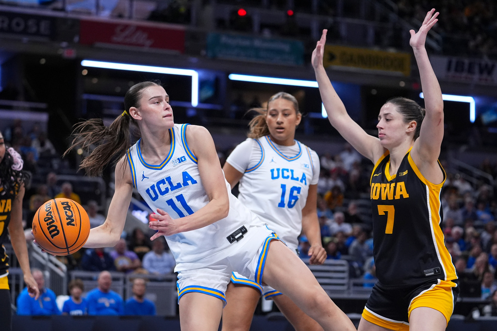 UCLA forward Gabriela Jaquez (11) grabs a rebound in front of Iowa guard Addison Deal (7) in the first half of an NCAA college basketball game in the finals of the Big Ten Conference tournament, Sunday, March 8, 2026 in Indianapolis. (AP Photo/Michael Conroy)