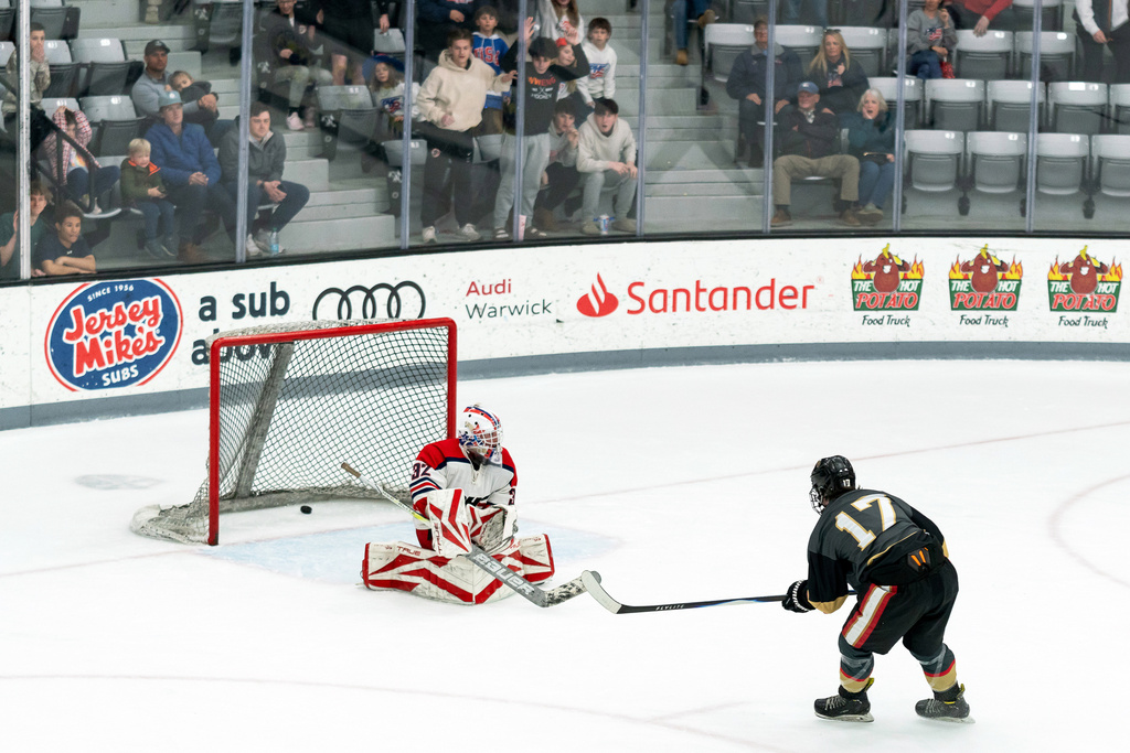 Blackstone Valley Schools forward Colin Dorgan shoots the puck past the goaltender to score the double-overtime game-winning goal against Portsmouth High School in the Rhode Island high school hockey state semifinal Wednesday, March 11, 2026, at Schneider Arena in Providence, R.I. (Courtesy of T.J. Auclair & Kyle Auclair/Little Big Leaguers Photography via AP)