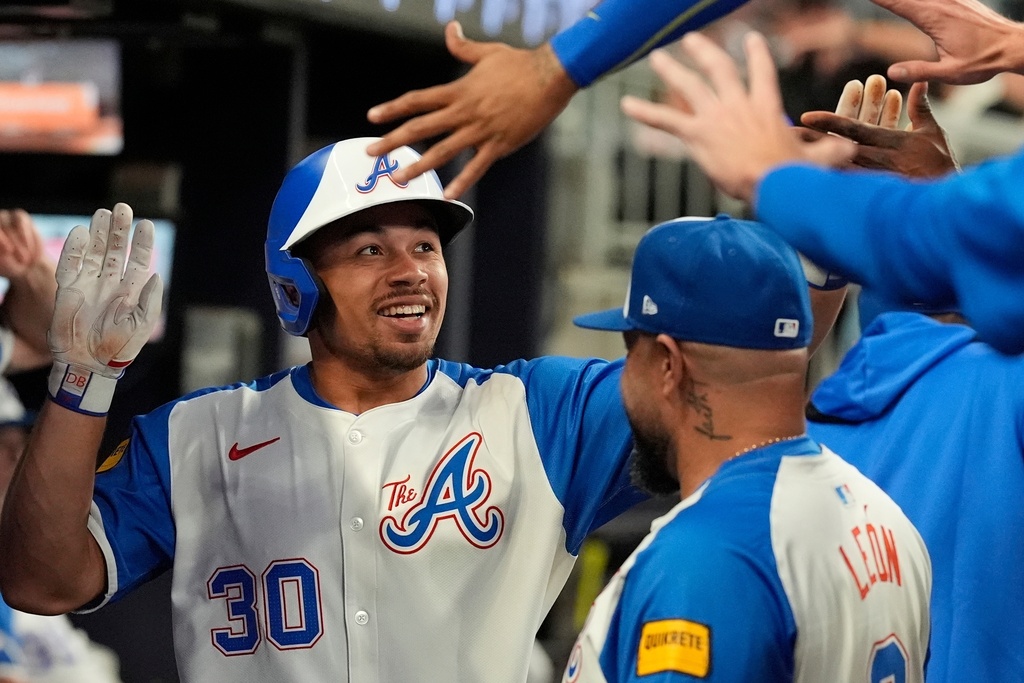 FILE - Atlanta Braves' Drake Baldwin (30) celebrates Marcell Ozuna (20) in the second inning of a baseball game against the Pittsburgh Pirates, Saturday, Sept. 27, 2025, in Atlanta. (AP Photo/Mike Stewart, file)