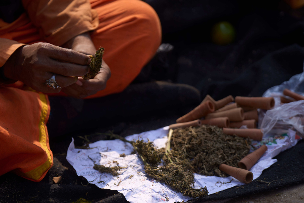 A man displays marijuana and smoking pots to sell to devotees during Maha Shivaratri festival at the Pashupatinath temple premises in Kathmandu, Nepal, Sunday, Feb. 15, 2026. (AP Photo/Niranjan Shrestha)