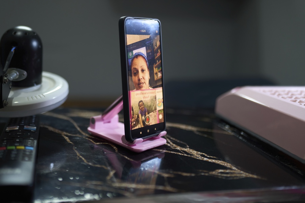 Syntia Caceres records a video to post on social media about her son who was detained in July in the U.S. and her four-year-old granddaughter Aurore who was subsequently placed in foster care in Georgia state, at her home in Caracas, Venezuela, Thursday, Sept. 4, 2025. (AP Photo/Ariana Cubillos)