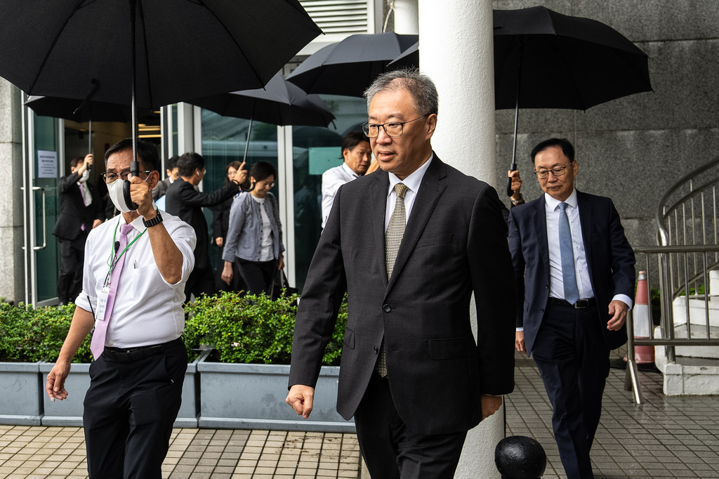 David Lok, chairman of the independent committee investigating last year's deadly Tai Po fire leaves following the public hearing in Hong Kong, Wednesday, July 15, 2026. (AP Photo/Chan Long Hei)