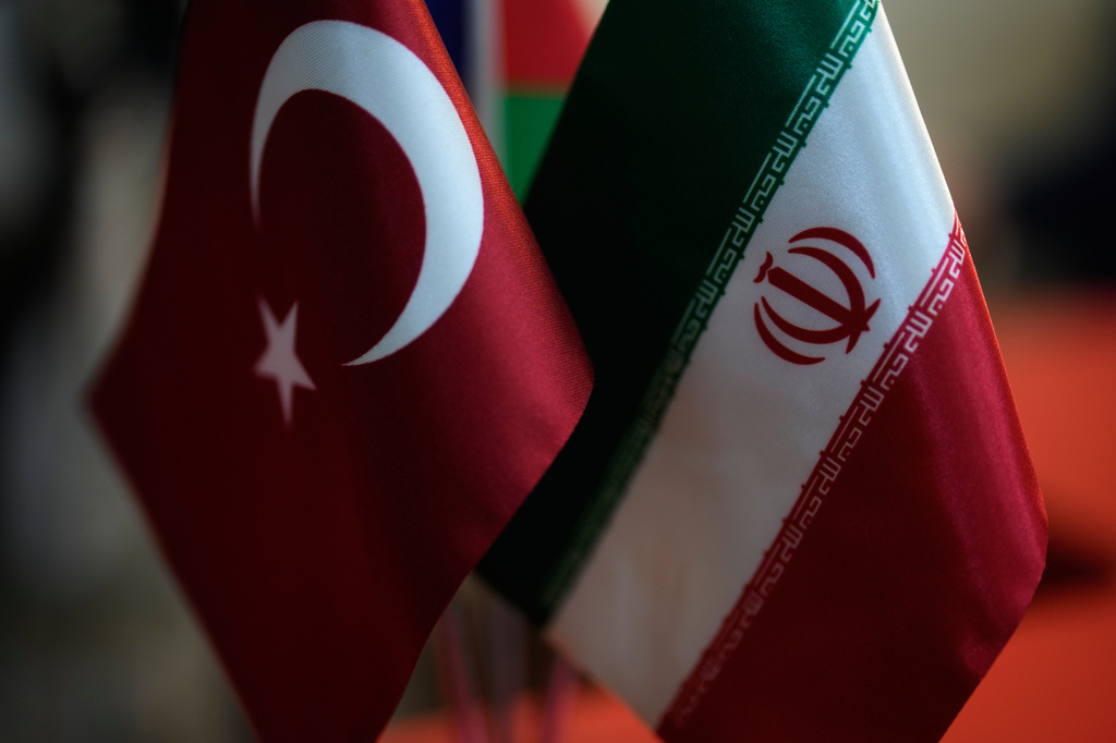 Turkish and Iranian flags are seen in an Iranian currency exchange business in the Aksaray district of Istanbul on Monday, April 13, 2026. (AP Photo/Khalil Hamra)