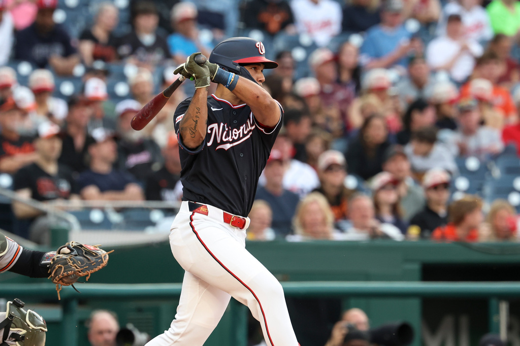 Washington Nationals' Daylen Lile follows through on his swing after hitting a double against Baltimore Orioles pitcher Shane Baz during the second inning of a baseball game, Friday, May 15, 2026, in Washington. (AP Photo/Terrance Williams)