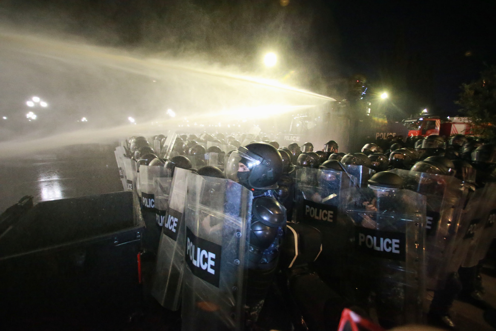Police use a water cannon to block protesters during an opposition rally in the city center of Tbilisi, Georgia, on Saturday, Oct. 4, 2025, boycotting the municipal elections and call for the release of political opponents. (AP Photo/Zurab Tsertsvadze)