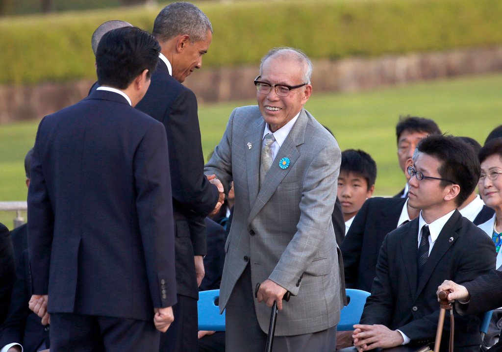 FILE - U.S. President Barack Obama, second from left, shakes hands with Shigeaki Mori, an atomic bomb survivor and a creator of the memorial for American WWII POWs killed in Hiroshima, during a ceremony at Hiroshima Peace Memorial Park in Hiroshima, western, Japan, May 27, 2016. (AP Photo/Shuji Kajiyama, File)