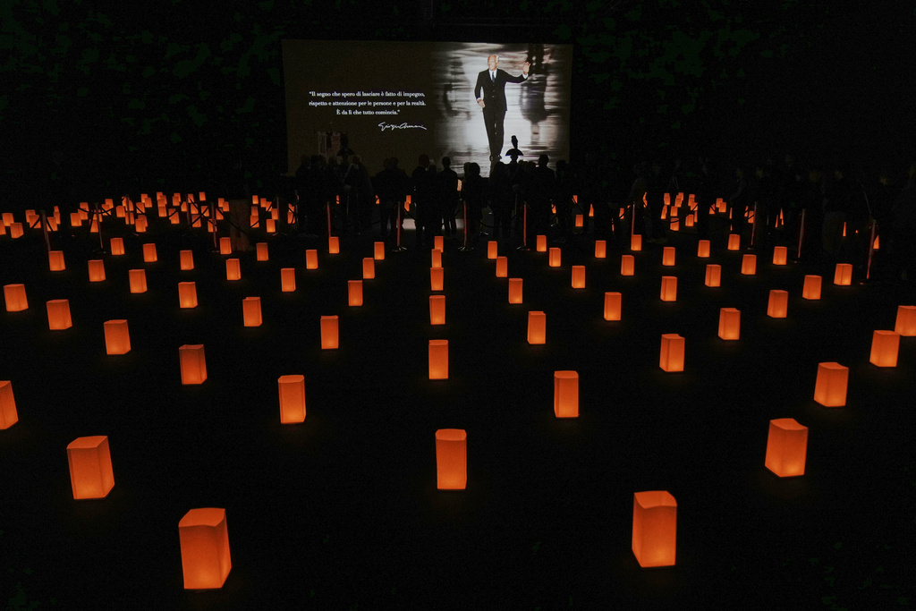 People pay their respects to fashion designer Giorgio Armani, lying in state at the Armani/Teatro in Milan, northern Italy, Saturday, Sept. 6, 2025. (AP Photo/Antonio Calanni)