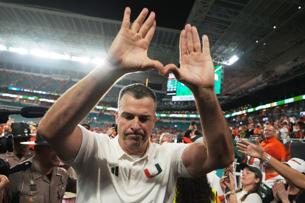 Miami head coach Mario Cristobal celebrates after Miami defeated Florida State in double overtime of an NCAA college football game, Saturday, Oct. 17, 2026, in Miami Gardens, Fla. (AP Photo/Lynne Sladky)