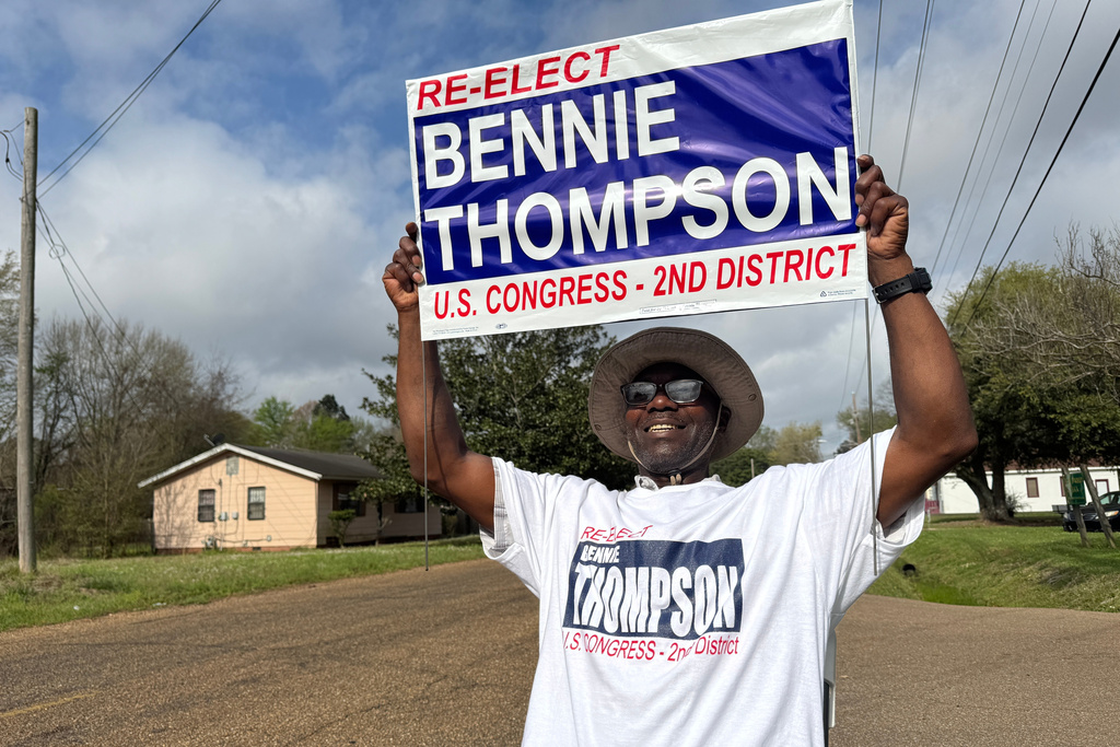Mark Hopson holds up a campaign sign for U.S. Rep. Bennie Thompson outside a polling location in Jackson, Miss. on Tuesday, March 10, 2026. (AP Photo/Sophie Bates)