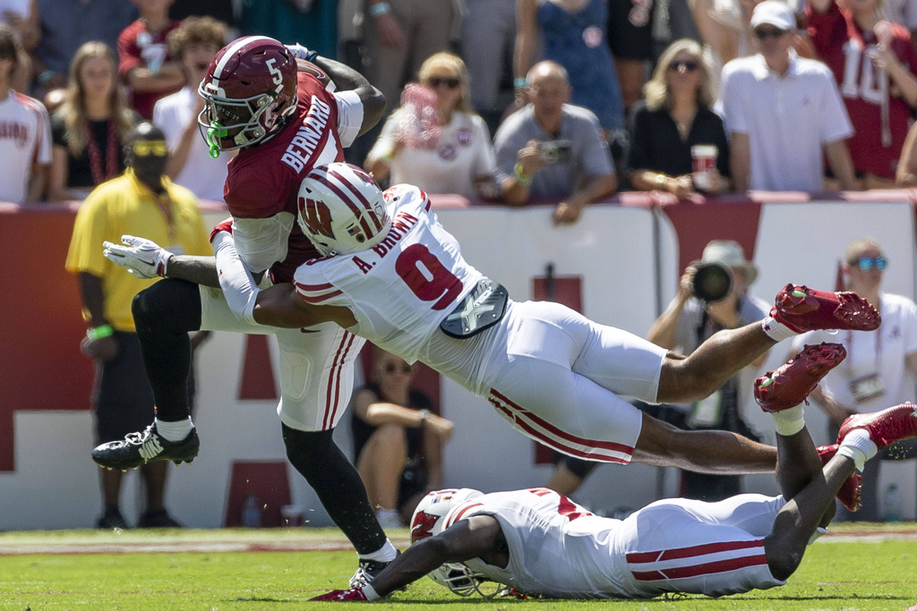 Alabama wide receiver Germie Bernard (5) runs from Wisconsin safety Austin Brown (9) during the first half of an NCAA college football game, Saturday, Sept. 13, 2025, in Tuscaloosa, Ala. (AP Photo/Vasha Hunt)