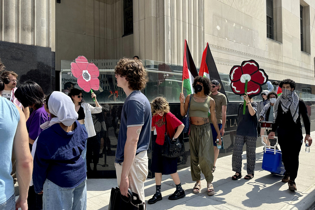 FILE - People carry Palestinian flags outside the federal courthouse in Detroit on Wednesday, June 10, 2026, after activists appeared in court on conspiracy charges. (AP Photo/Ed White, File)